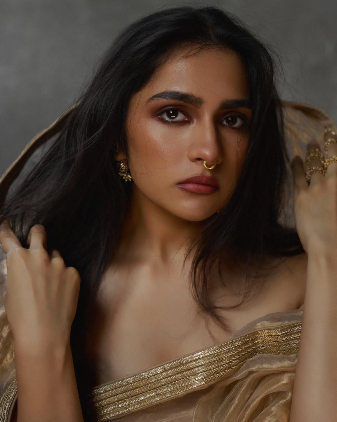 Rukmini Vasanth poised elegant golden photoshoot presence