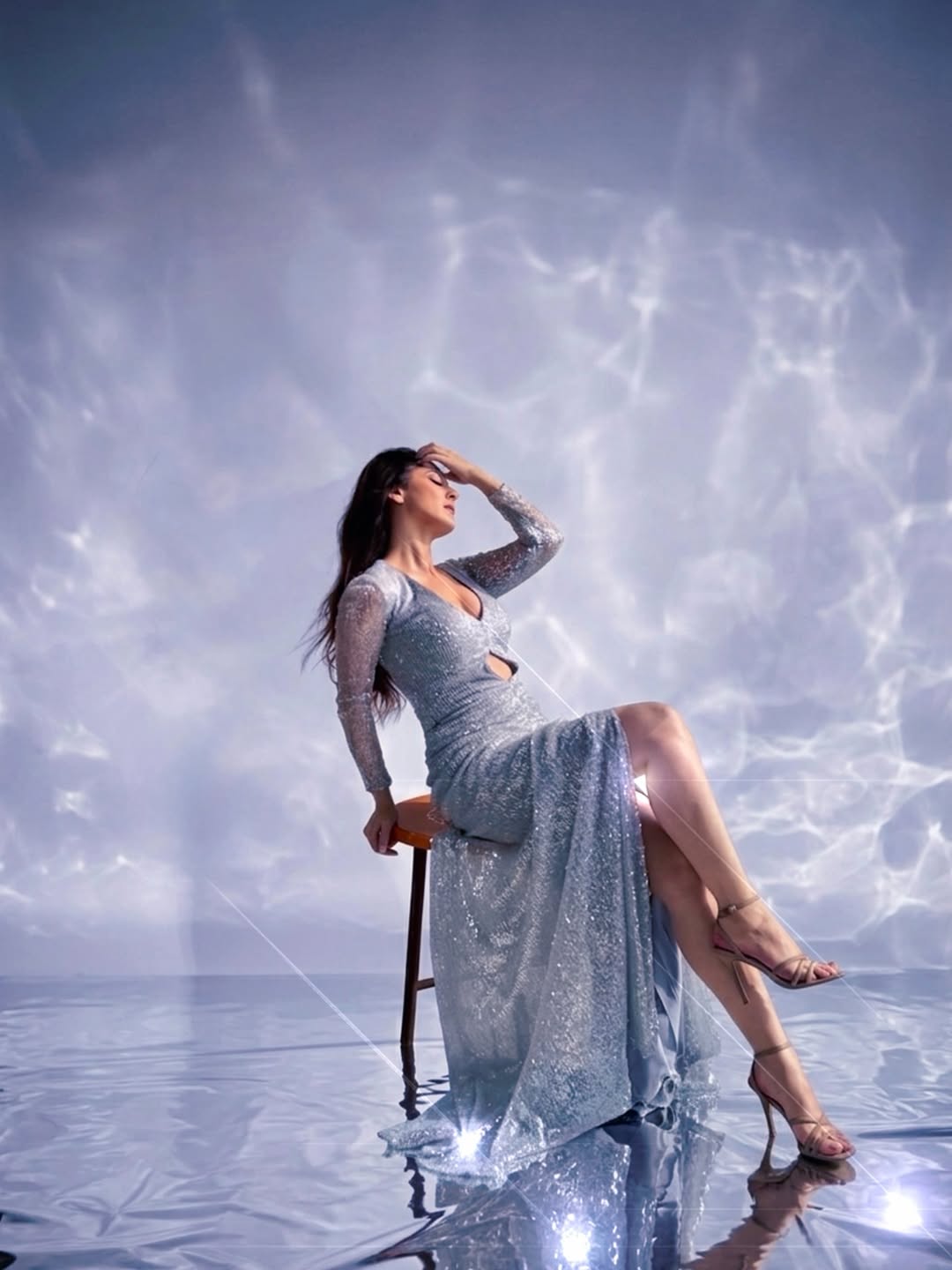 Sandeepa Dhar posing gracefully in sparkling silver dress
