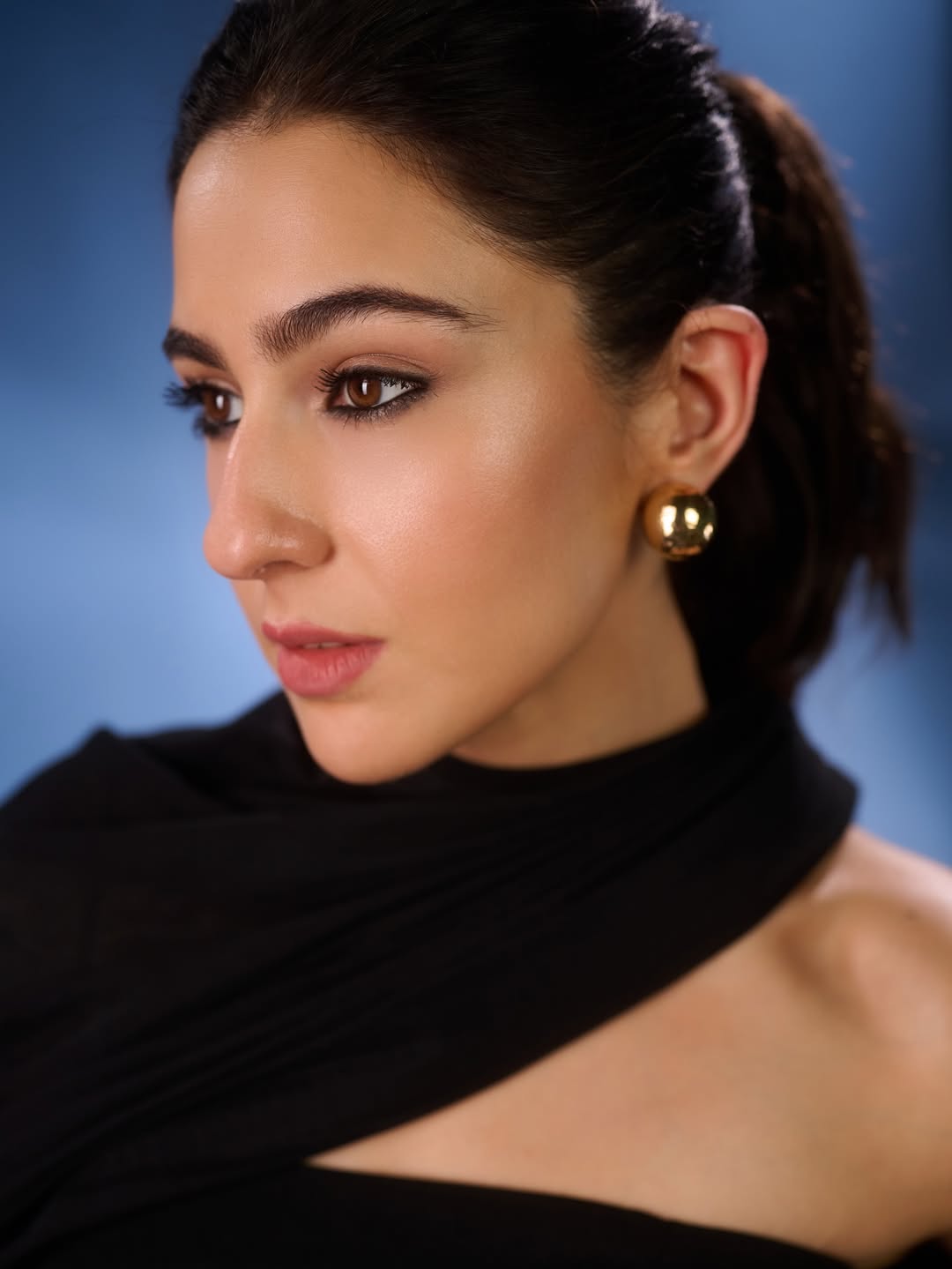 Sara Ali Khan wearing a black asymmetrical outfit with confident pose and elegant styling