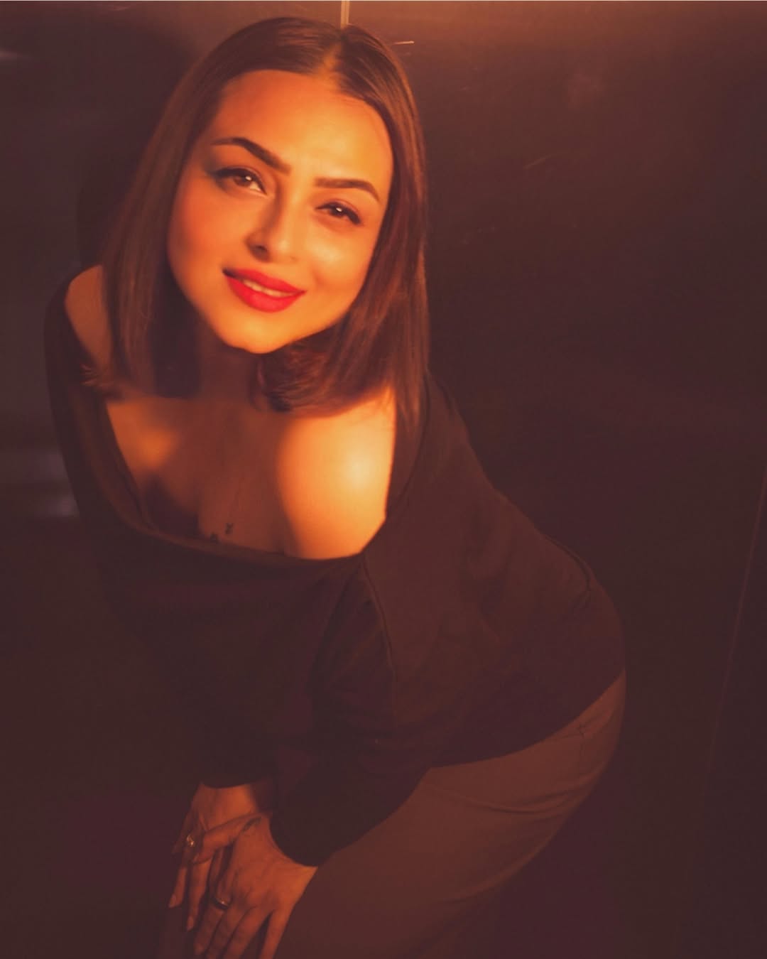 Shilpa Shirodkar posing in a black outfit with confident expression and soft smile