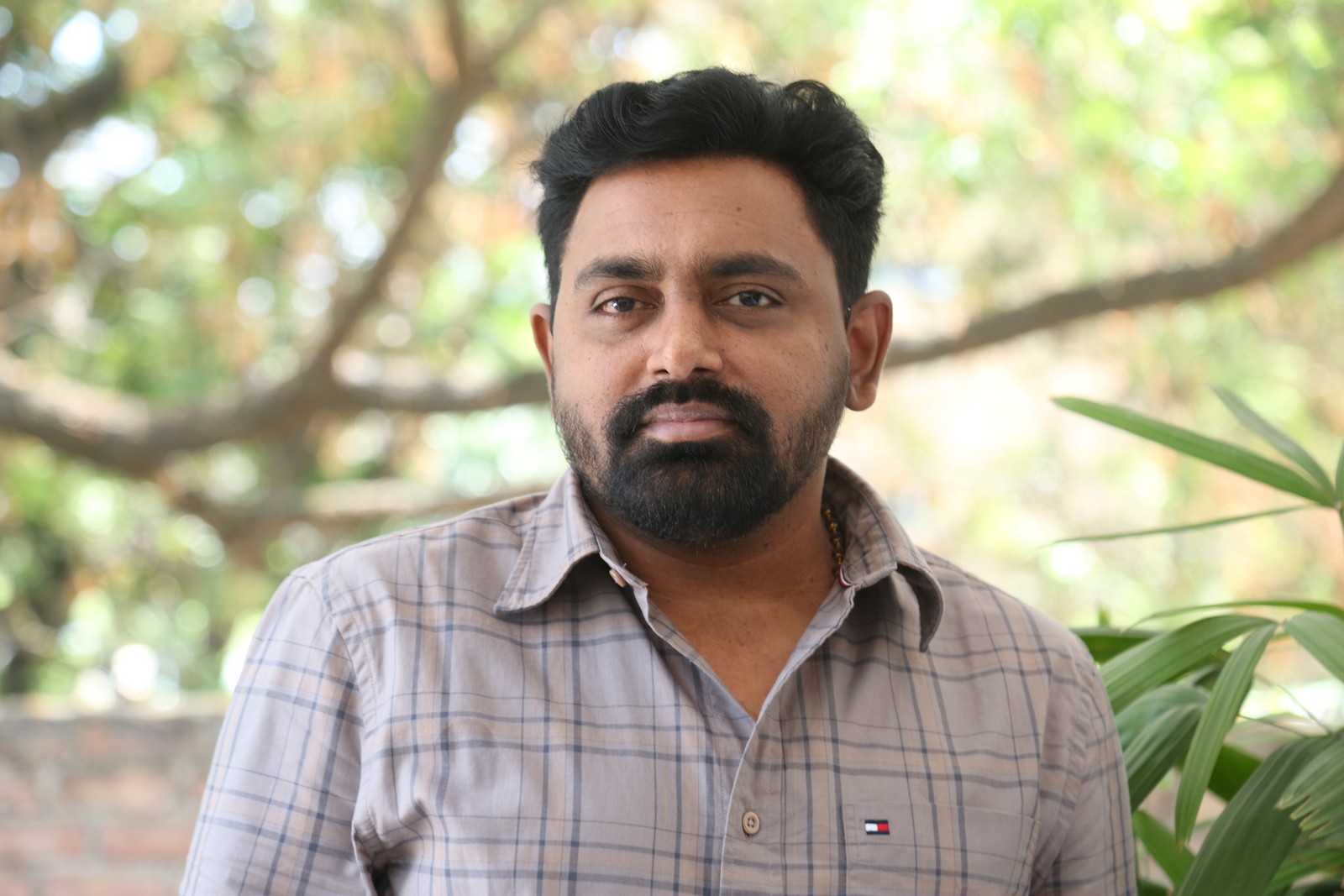 Shiva Prasad wearing check shirt with confident style
