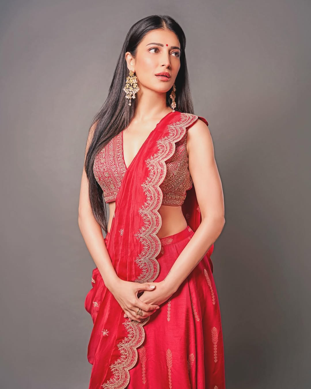 Shruti Haasan in red sari elegant pose graceful traditional fashion look