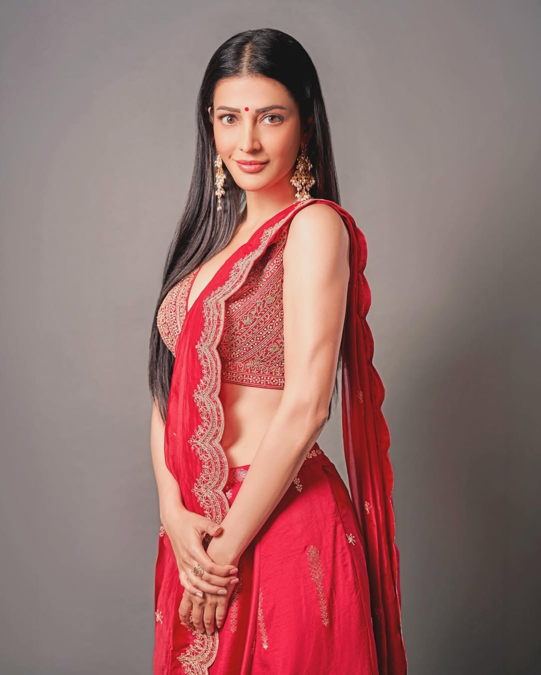 Shruti Haasan bold red sari look confident expression elegant styling