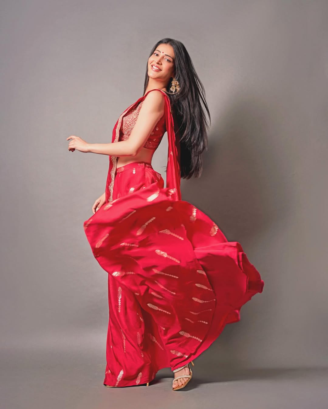 Shruti Haasan twirling sari vibrant traditional look smiling graceful pose