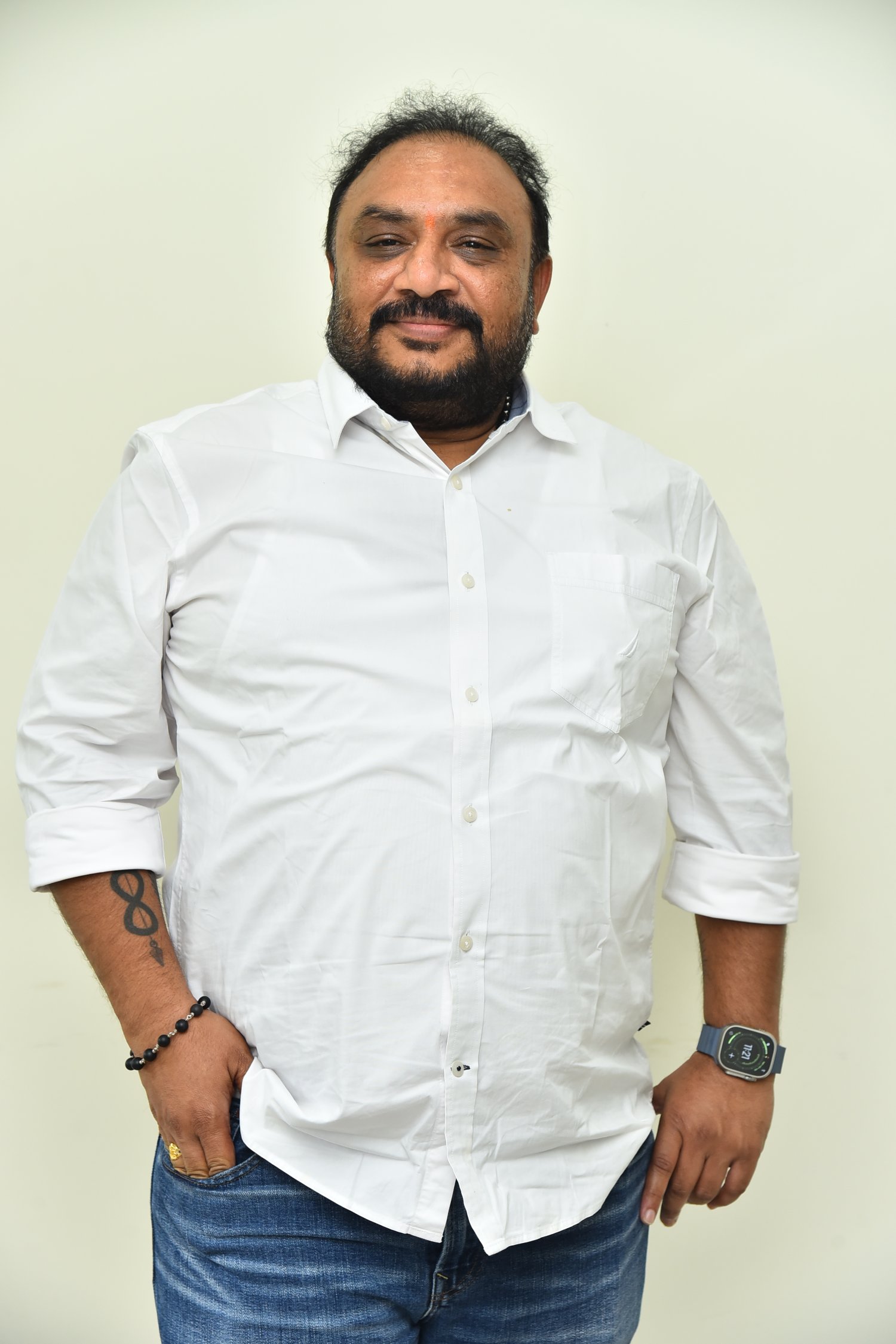 Srinivasa Rao Chinthalapudi in crisp white attire with stylish stance