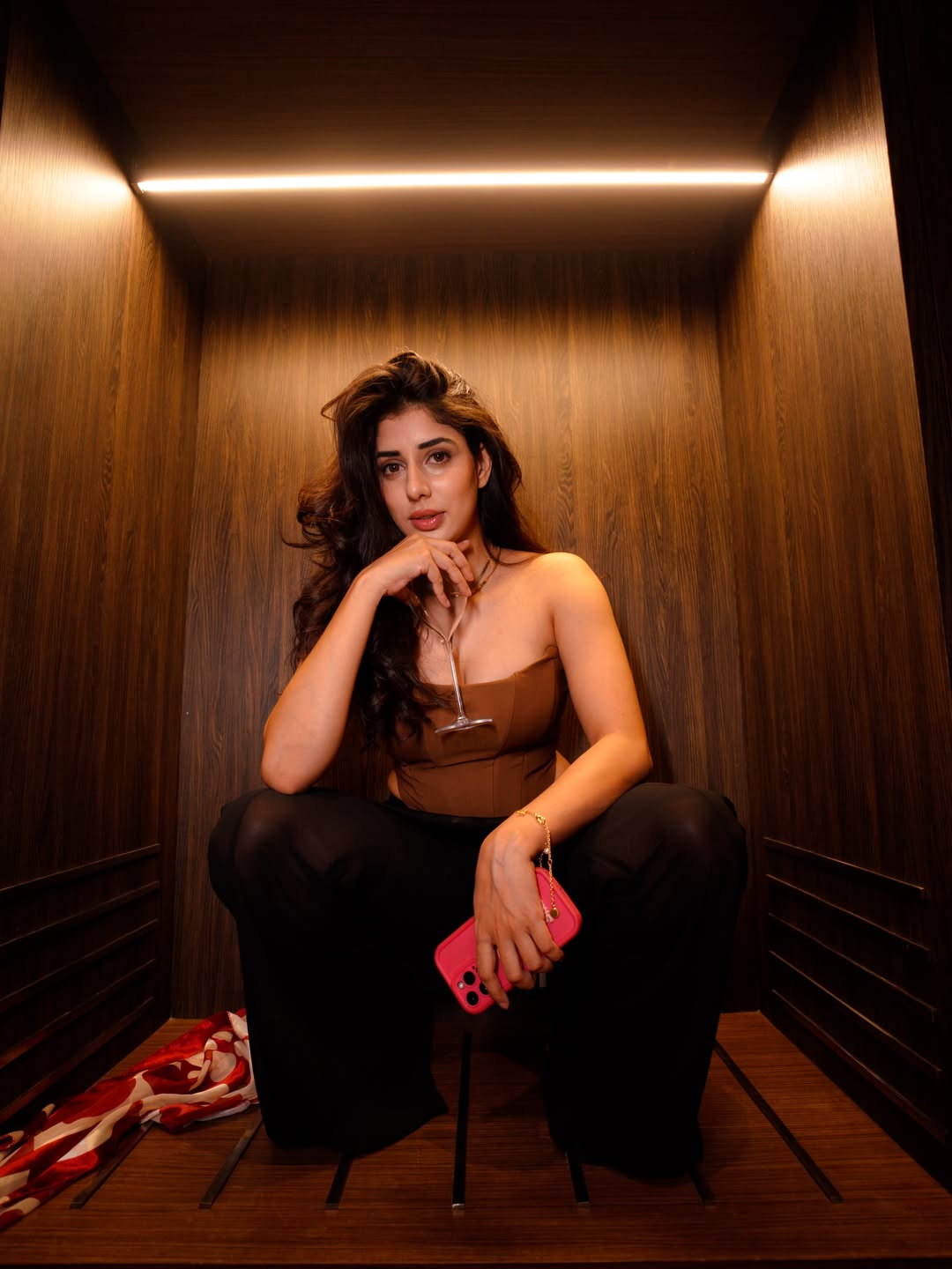Jasmin Bajwa stylish elevator selfie with bold pink phone