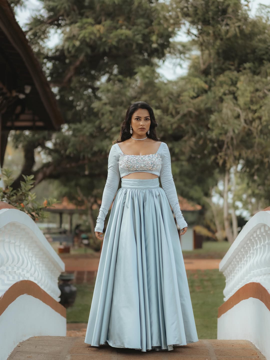 Amala Paul posing in dramatic elegant outfit