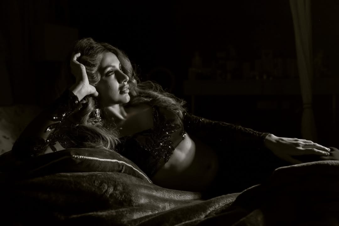 Tejaswi Madivada striking a confident pose in an artistic monochrome portrait.