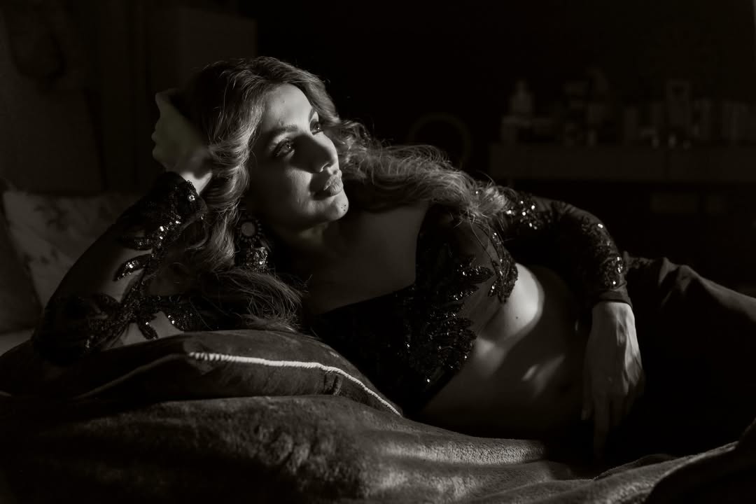 Tejaswi Madivada relaxing stylishly in a chic black-and-white fashion shoot.