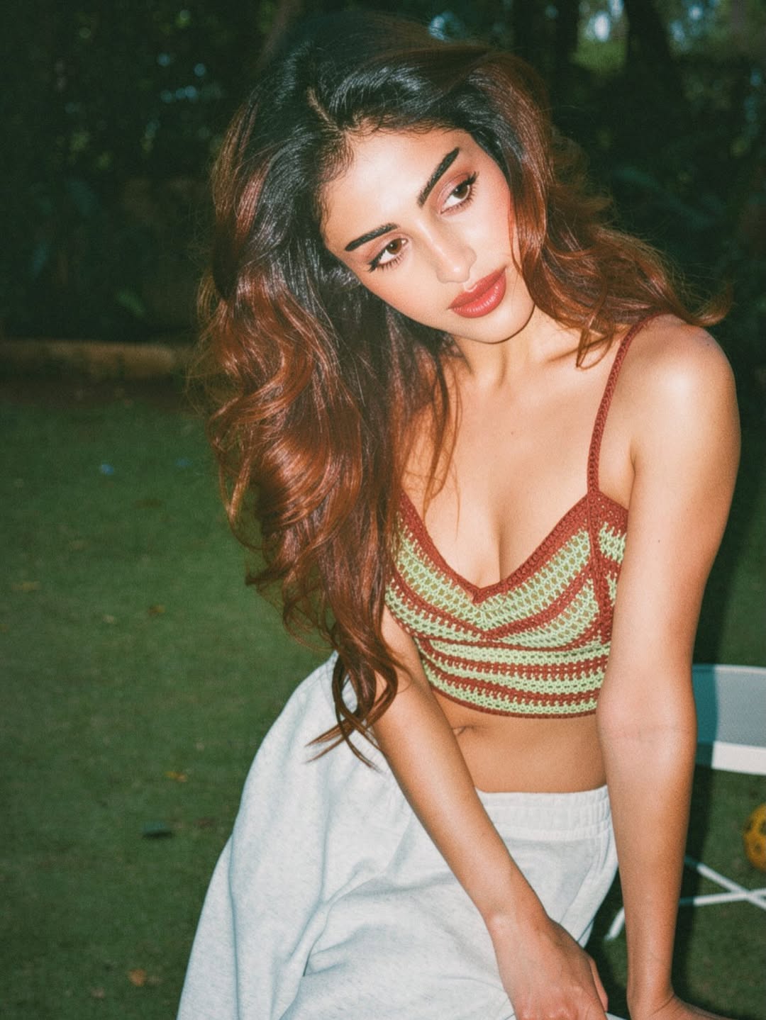 Priya Banerjee showcasing cozy bohemian fashion in an outdoor photoshoot.