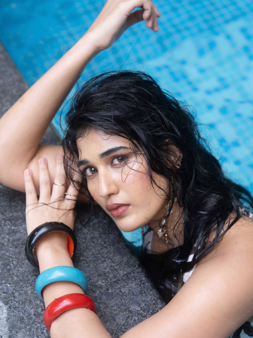 Amrutha Chowdary posing in chic zebra-print poolside outfit