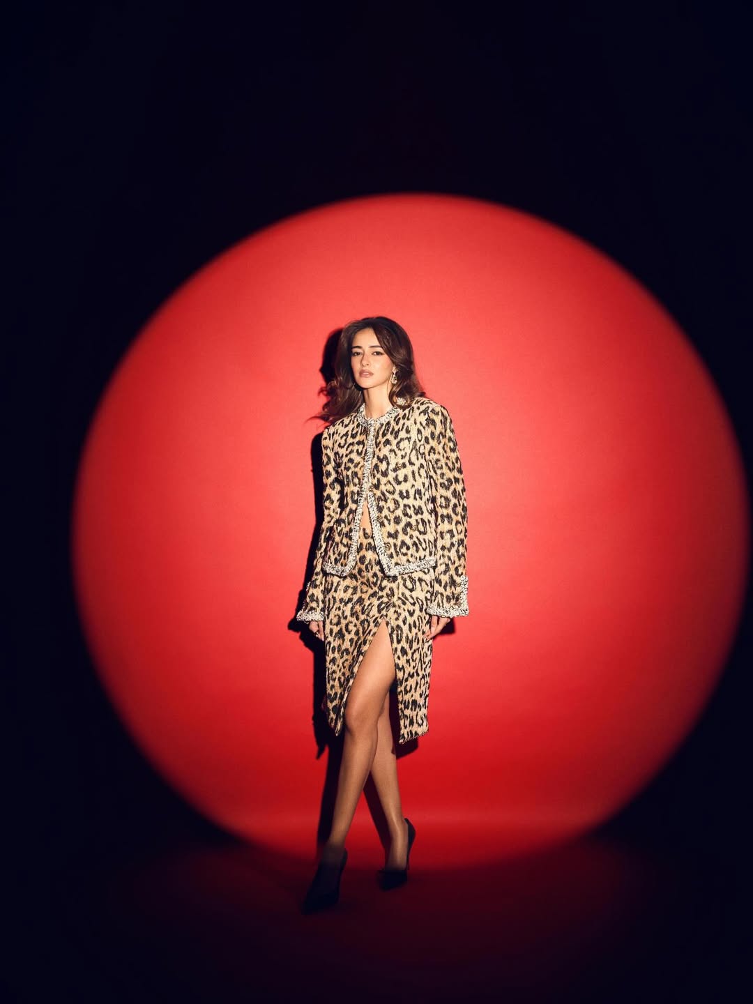 Ananya Panday posing confidently in a chic leopard-print ensemble with elegant styling.