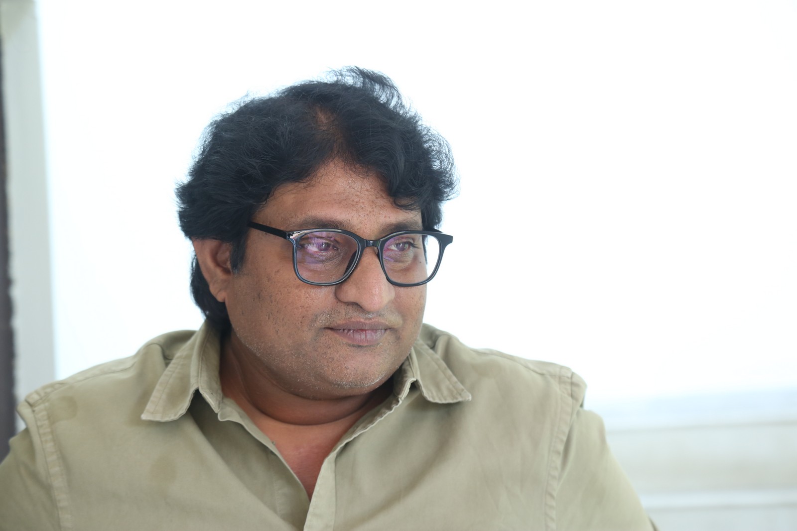 Avinash Kolla posing confidently in a classic formal shirt