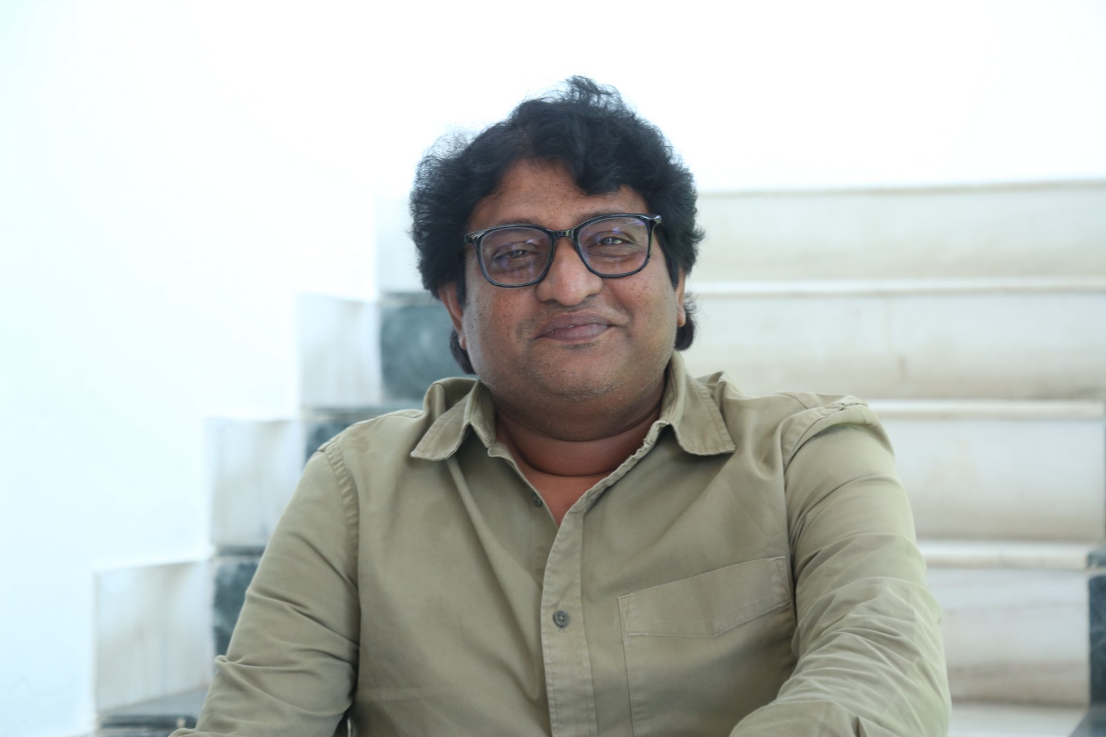 Avinash Kolla wearing stylish attire with sophisticated expression