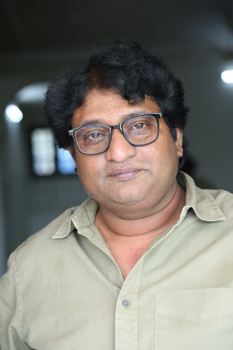 Avinash Kolla posing stylishly in a smart casual outfit