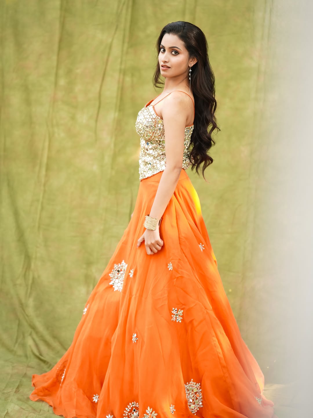 Deepika Pilli orange gown glamorous pose