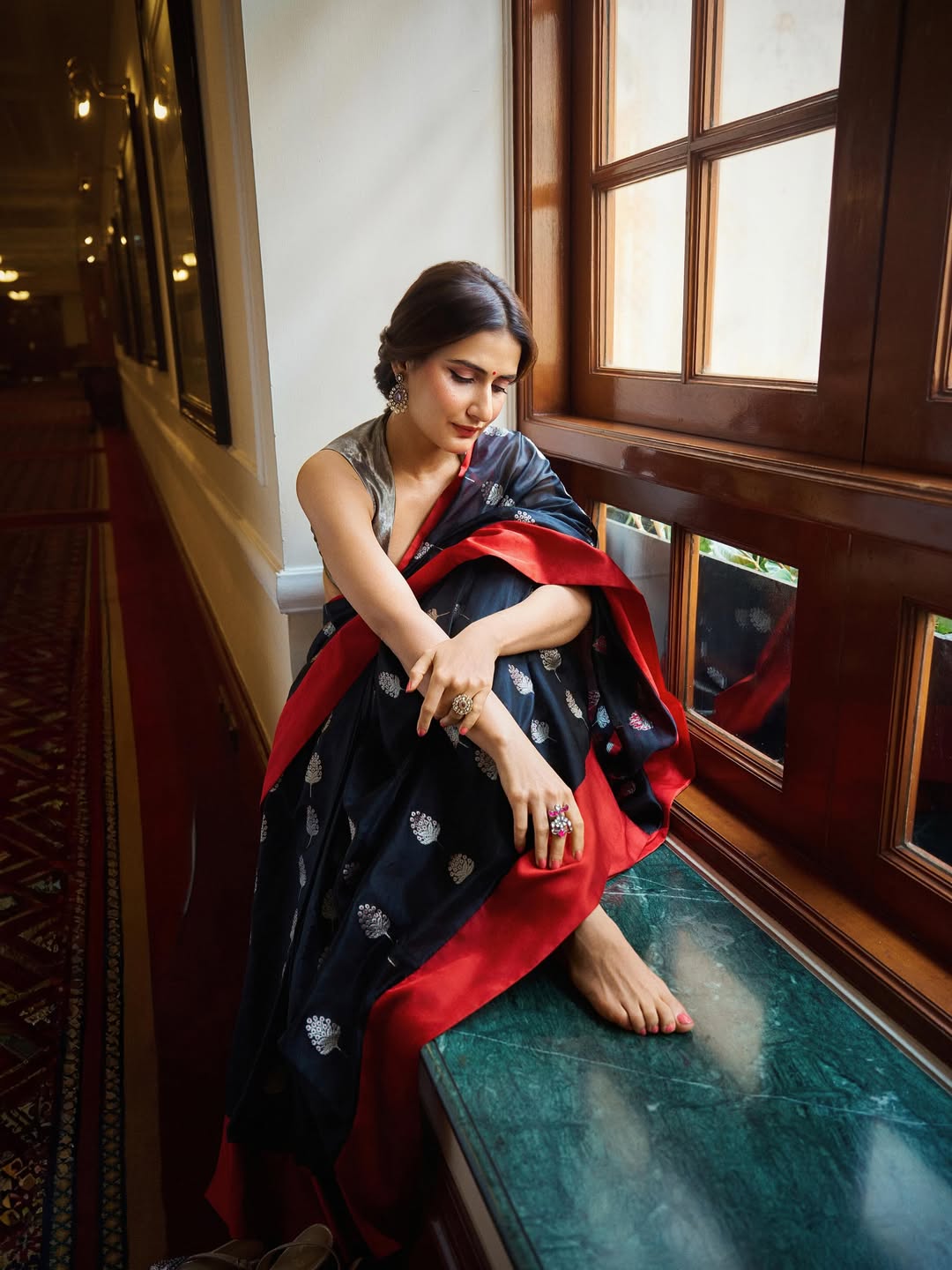 Fatima Sana Shaikh posing gracefully in saree near window
