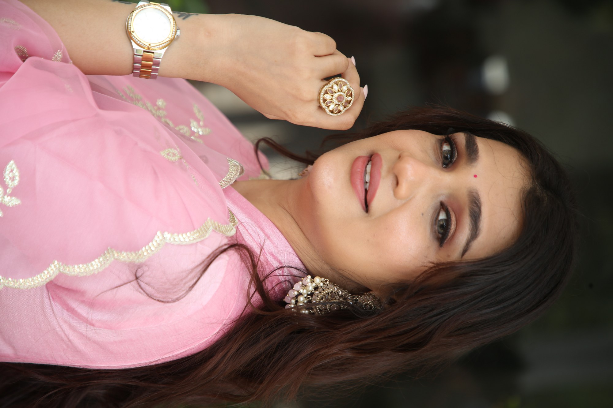 Hasini Sudhir elegant pink attire with stylish watch