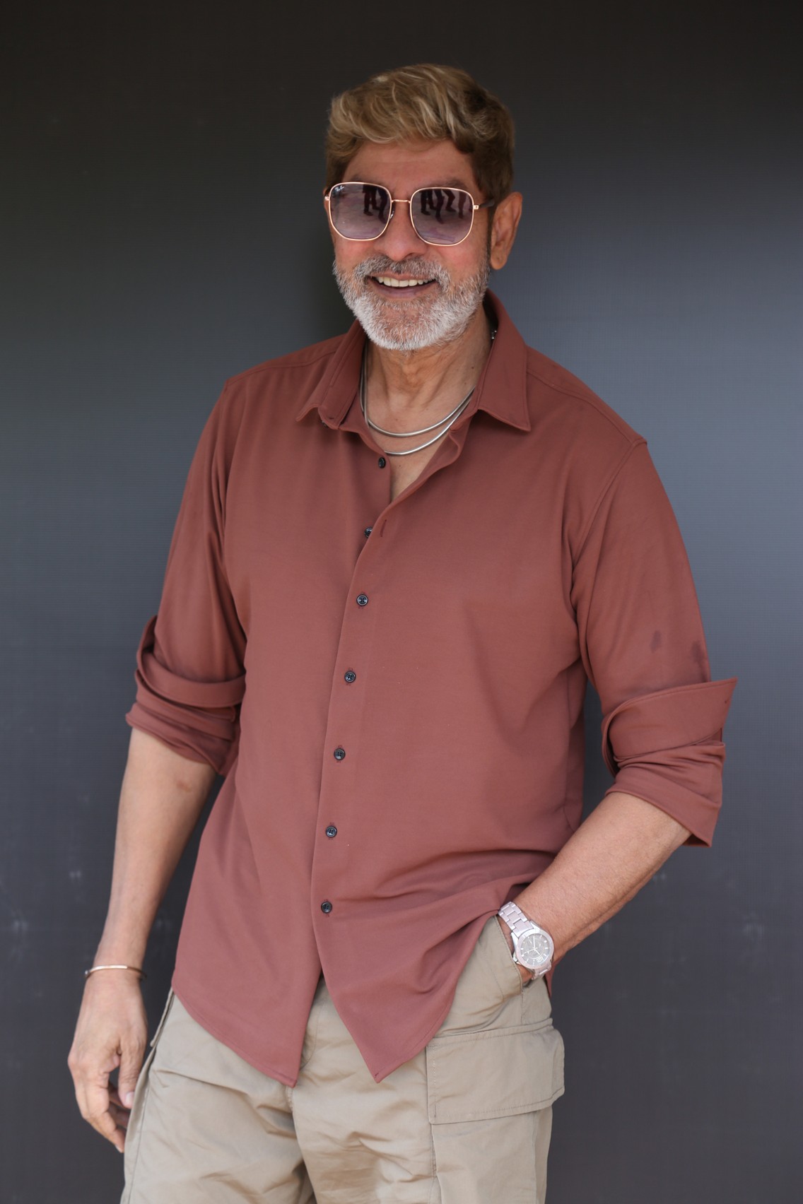 Jagapathi Babu stylishly posing in modern casual clothing.
