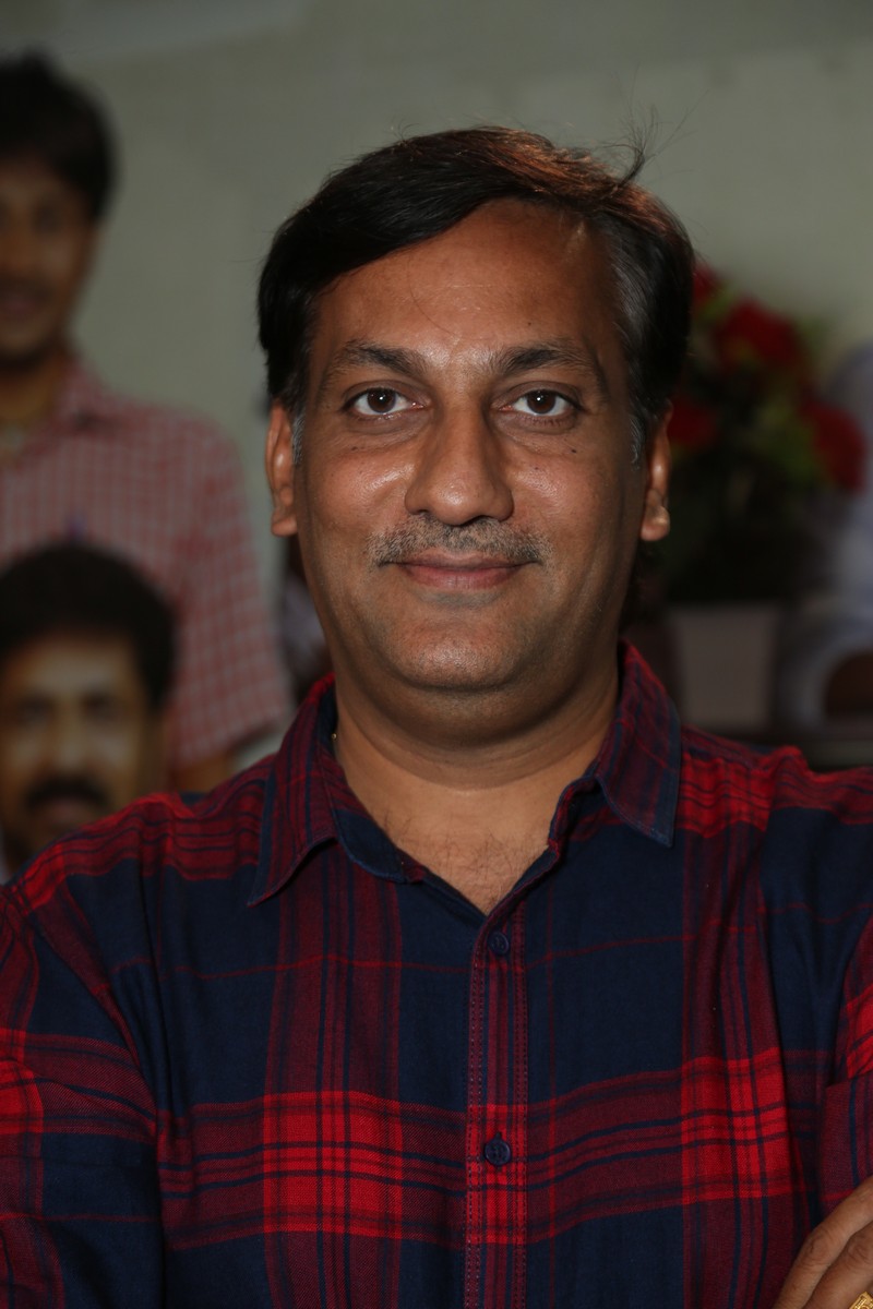 Karthikeya Kommi in red navy plaid shirt