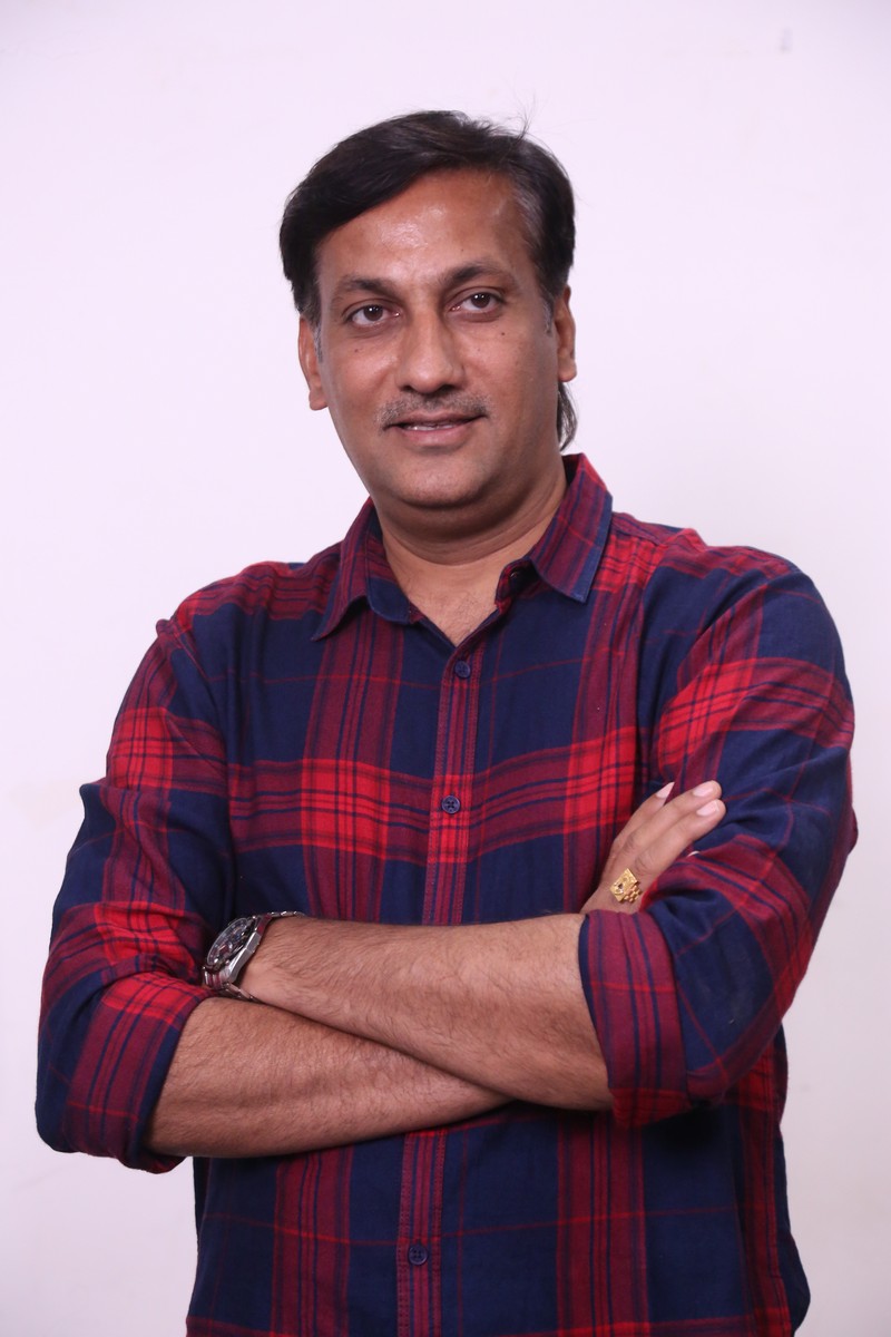 Karthikeya Kommi wearing casual checked shirt