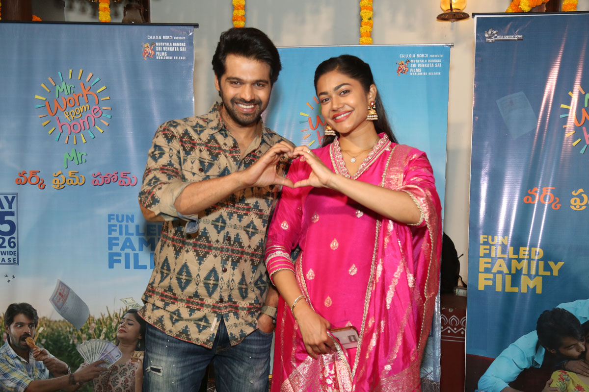 Thrigun and Payal Radhakrishna posing with heart gesture at event