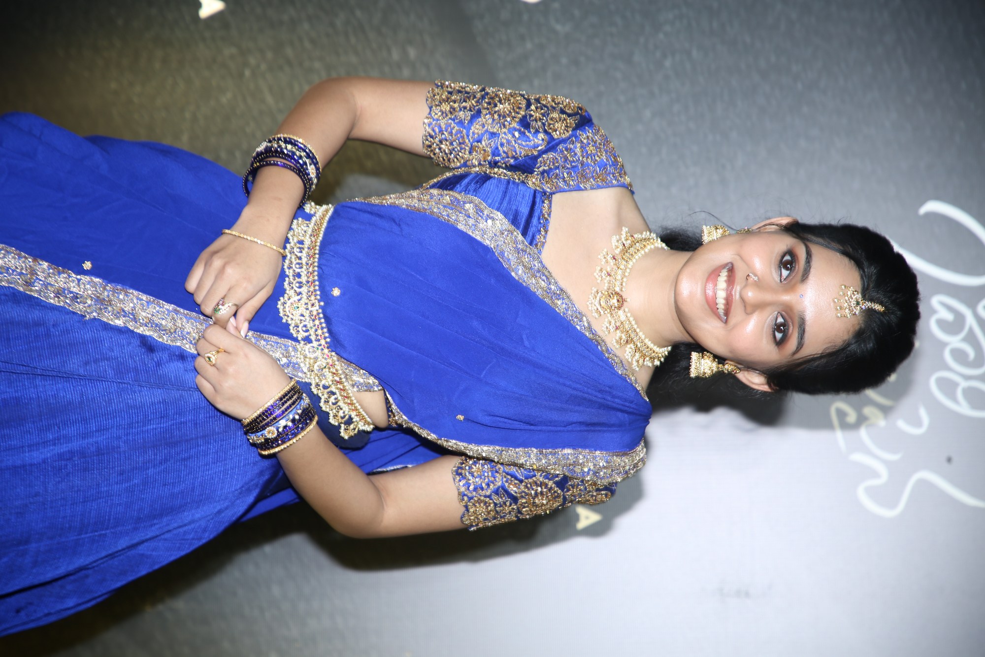 Nidhi Pradeep posing gracefully in a royal blue traditional outfit with elegant styling.