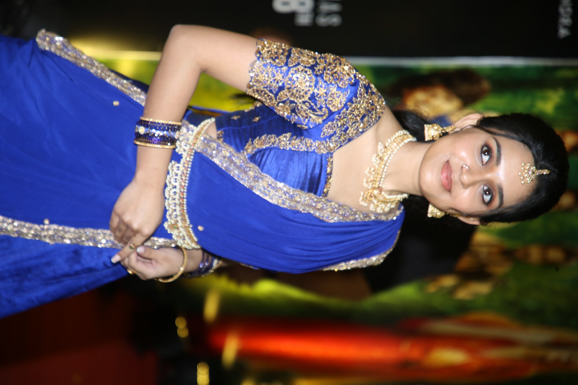 Actress Nidhi Pradeep flaunting a royal blue saree with detailed golden embellishments.