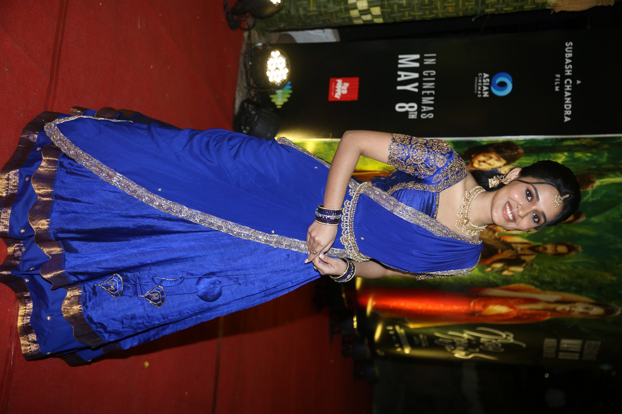 Nidhi Pradeep wearing a beautifully styled blue traditional outfit with regal elegance.