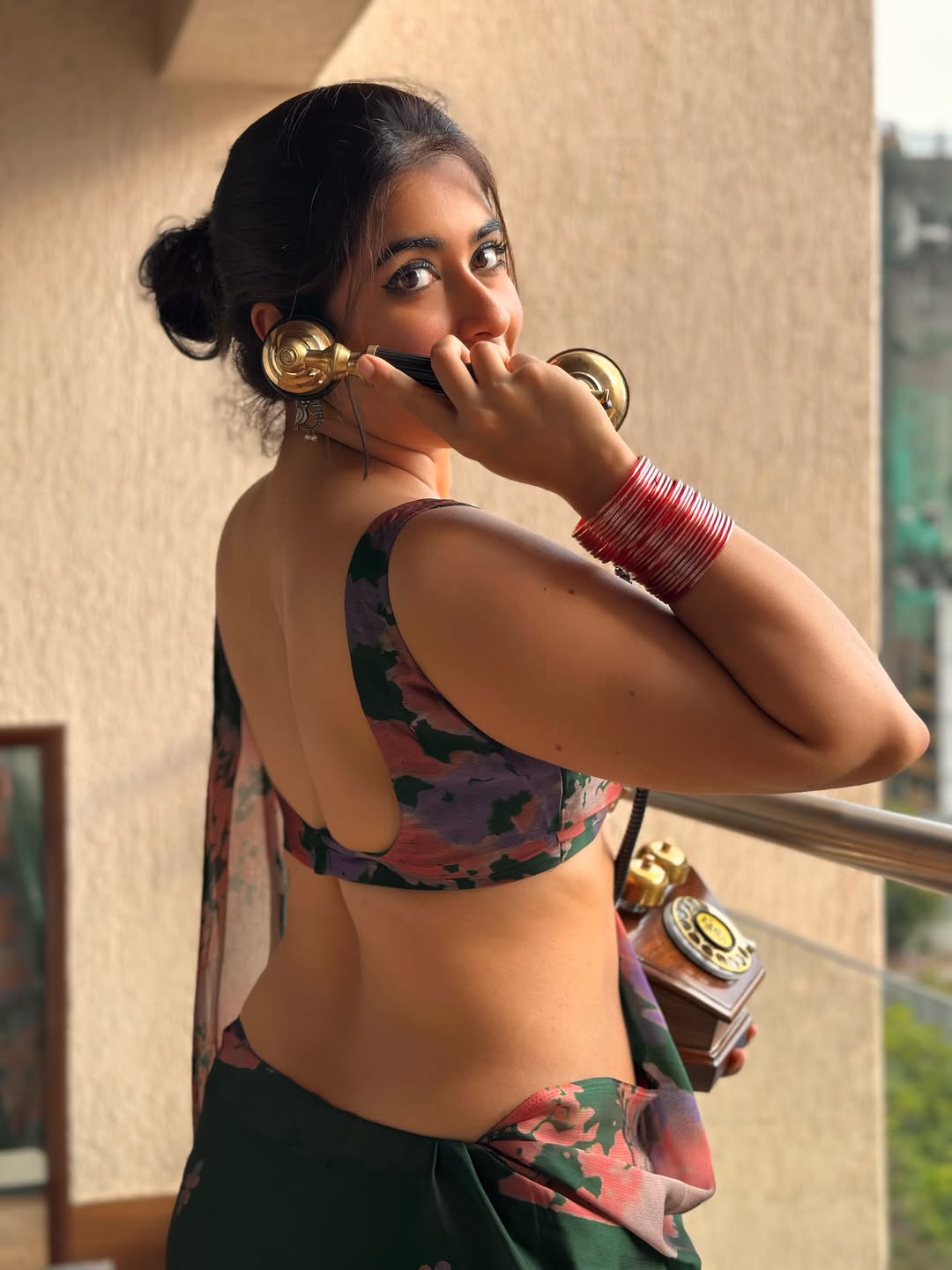 Nikita Sharma posing with retro phone accessory