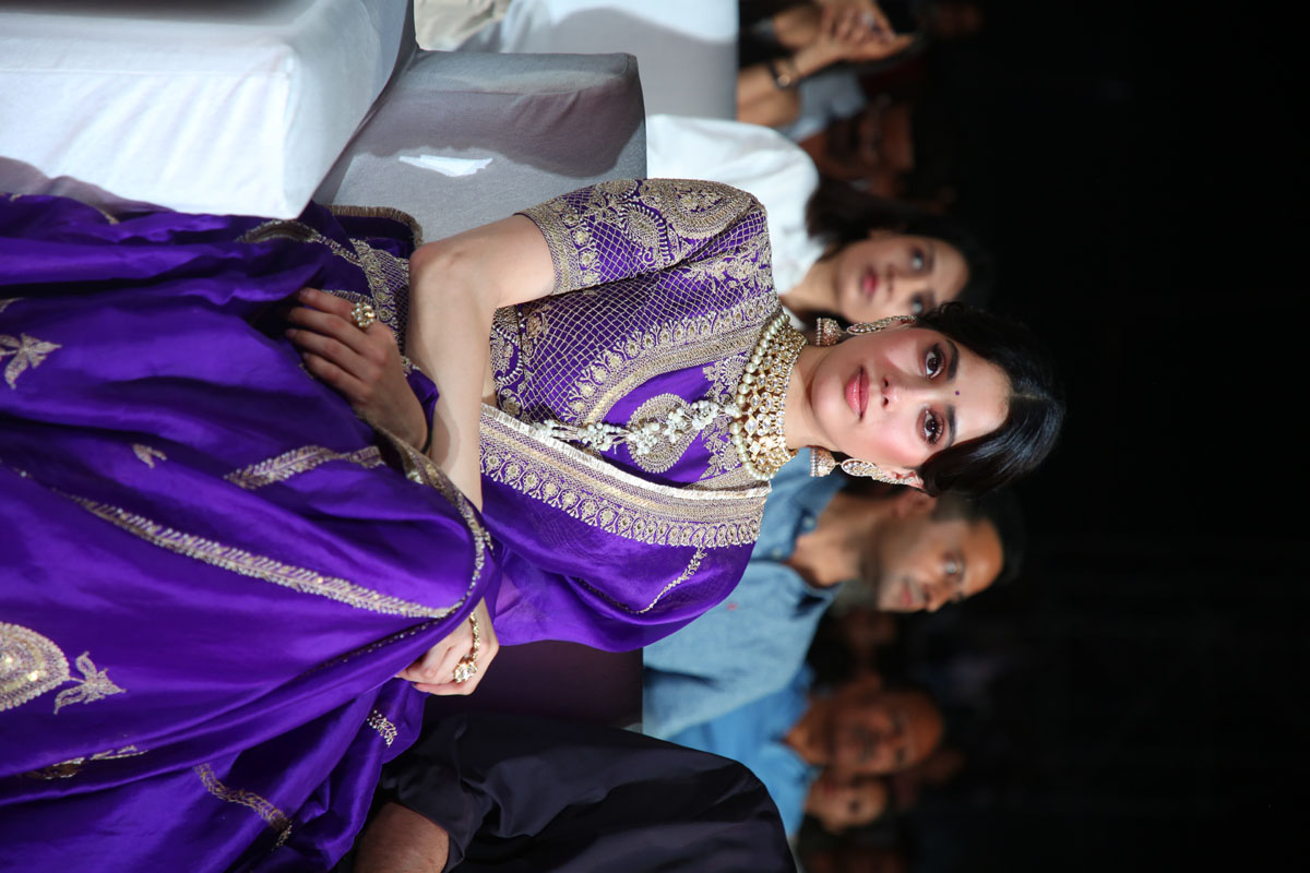 Janhvi Kapoor seated at the promotional event of Ram Charan's upcoming film.