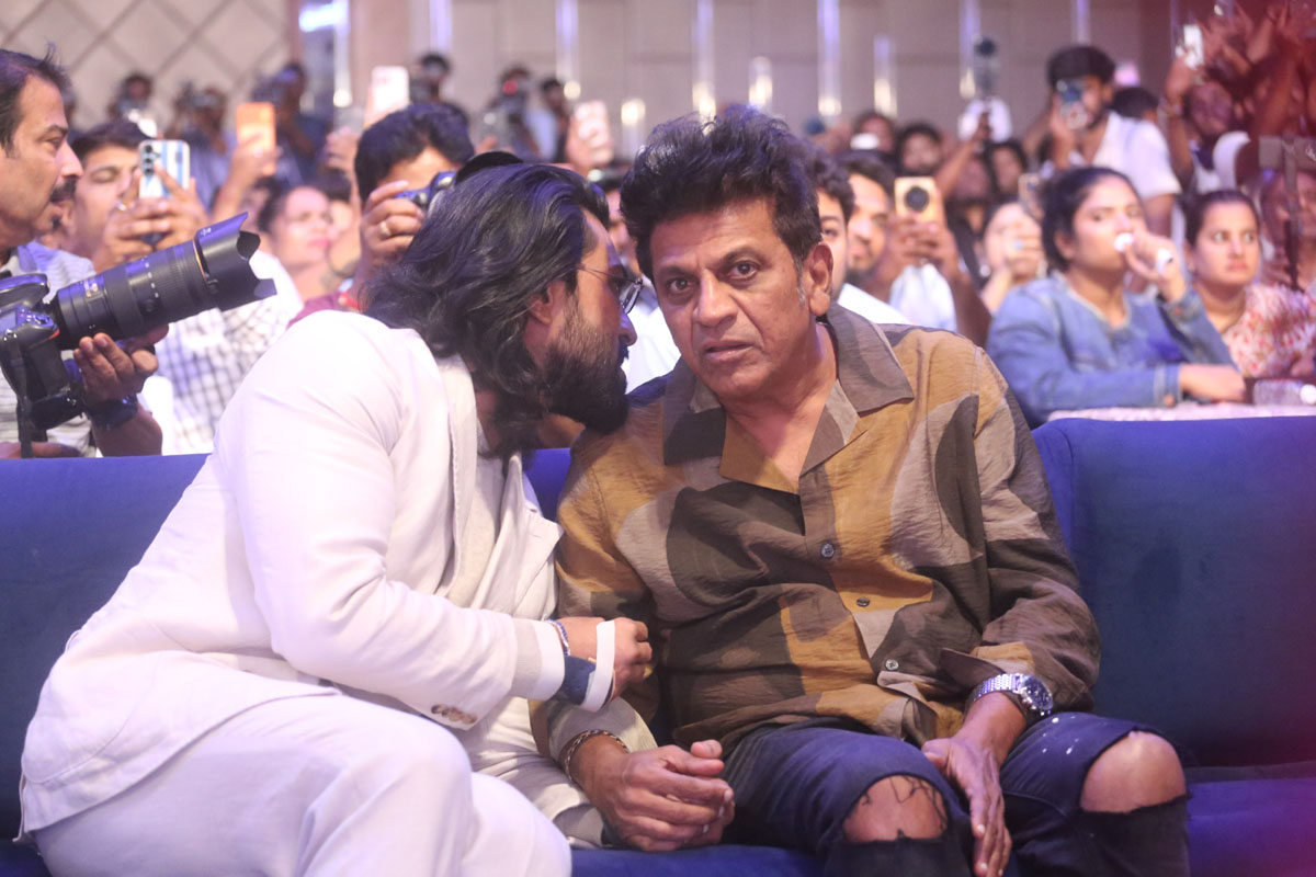 Ram Charan and Shiva Rajkumar conversing at Peddi event