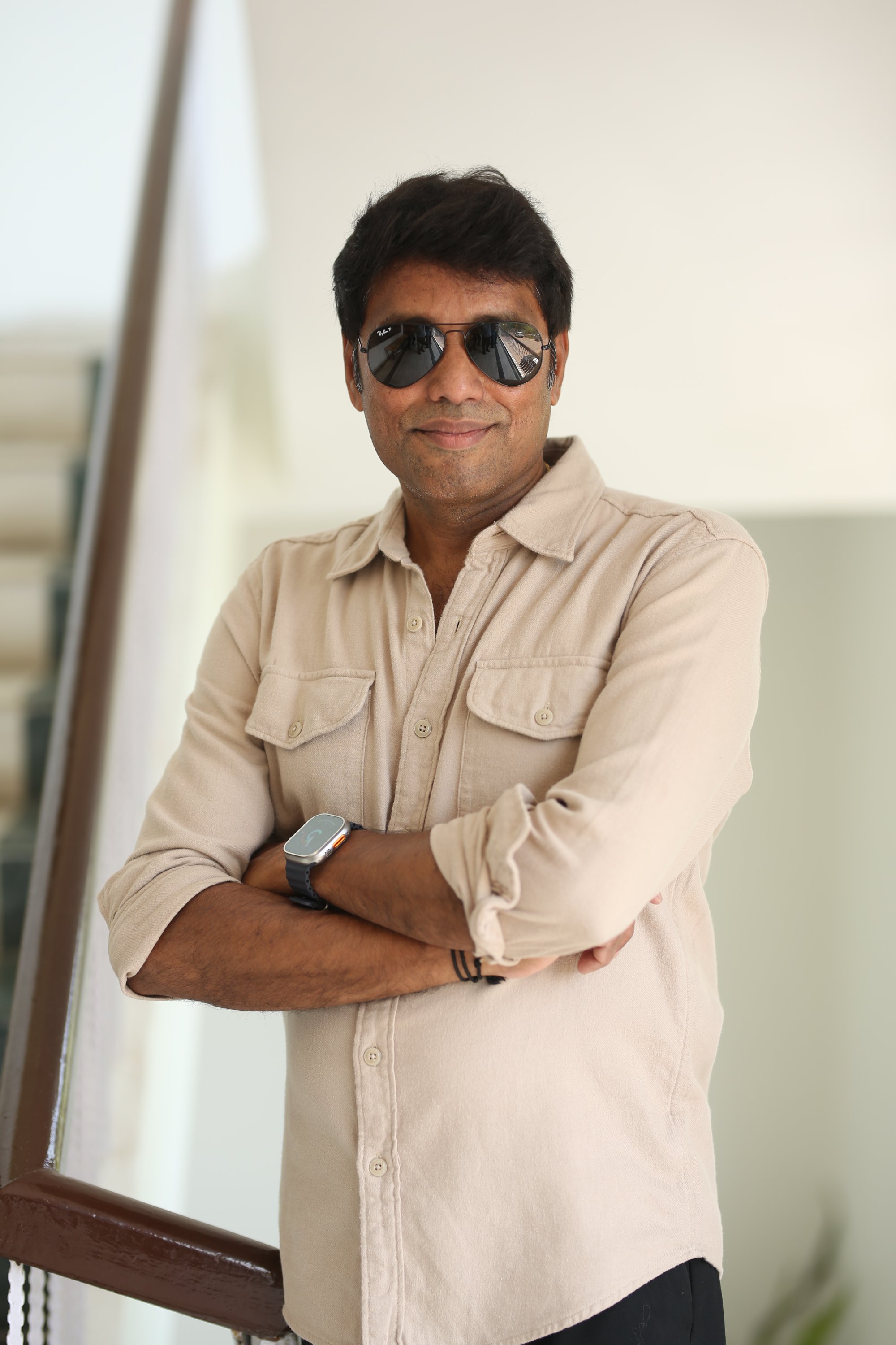 Rathnavelu posing confidently in a modern casual fashion look.