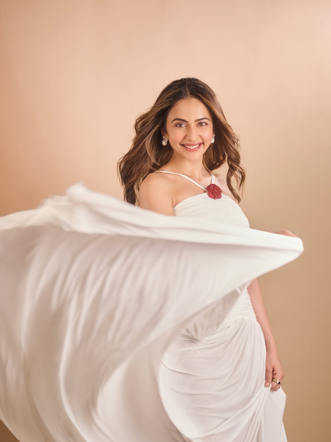 Rakul Preet Singh posing in flowing white gown