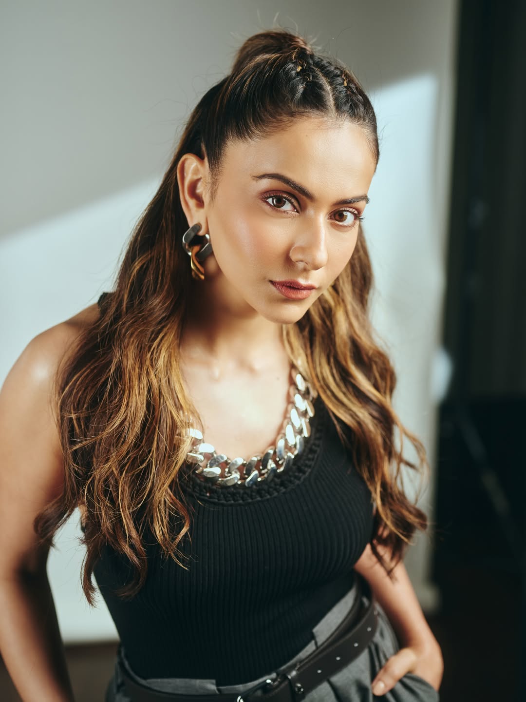 Rakul Preet Singh in black tank top and grey trousers