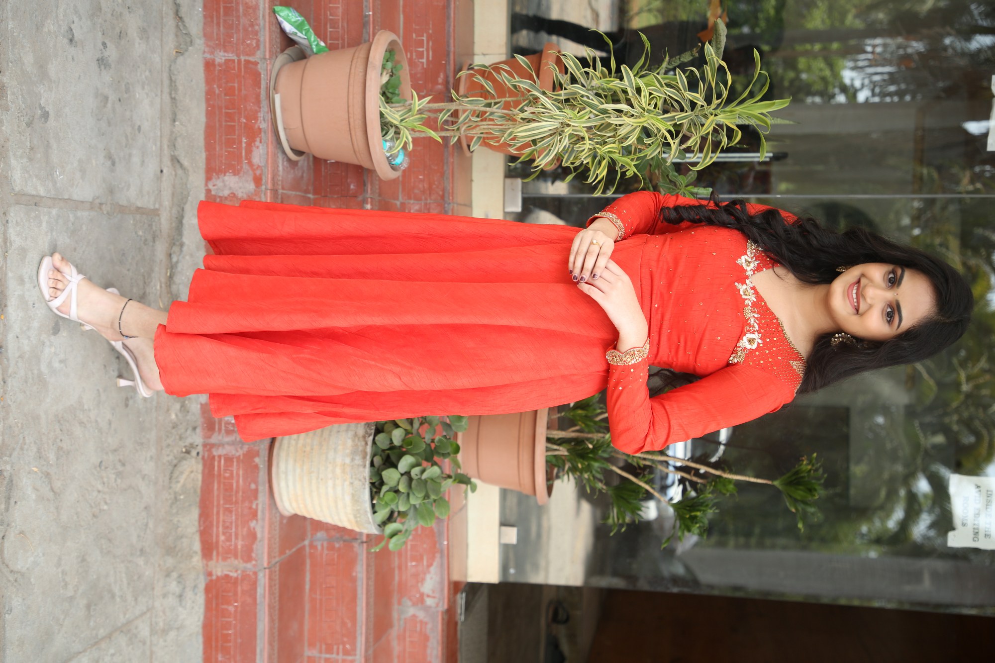 Rayancha Kokkura glowing beautifully in vibrant red dress