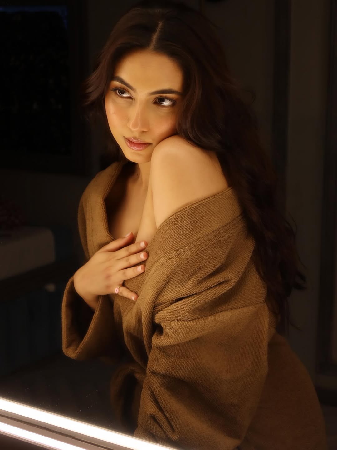 Reem Shaikh posing elegantly in stylish bathrobe