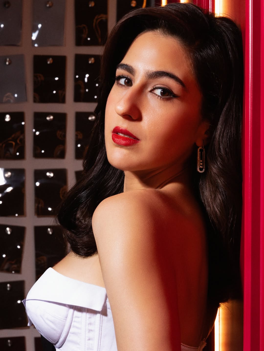 The Red Background Adds Cinematic Drama