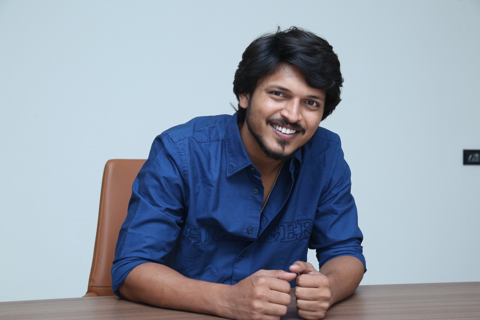 Sumanth Prabhas posing stylishly in a blue shirt