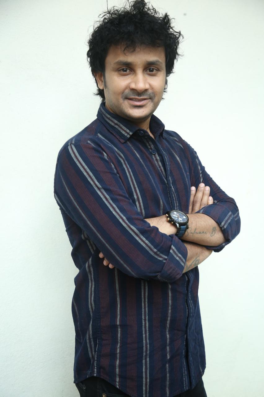 Suvixith Bojja wearing striped shirt with curly hairstyle