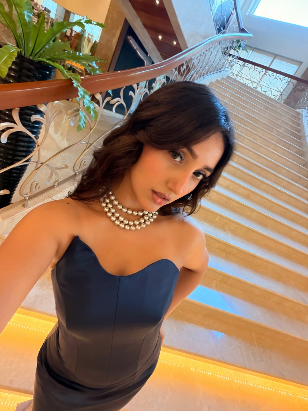 Ashnoor Kaur in navy dress with pearls