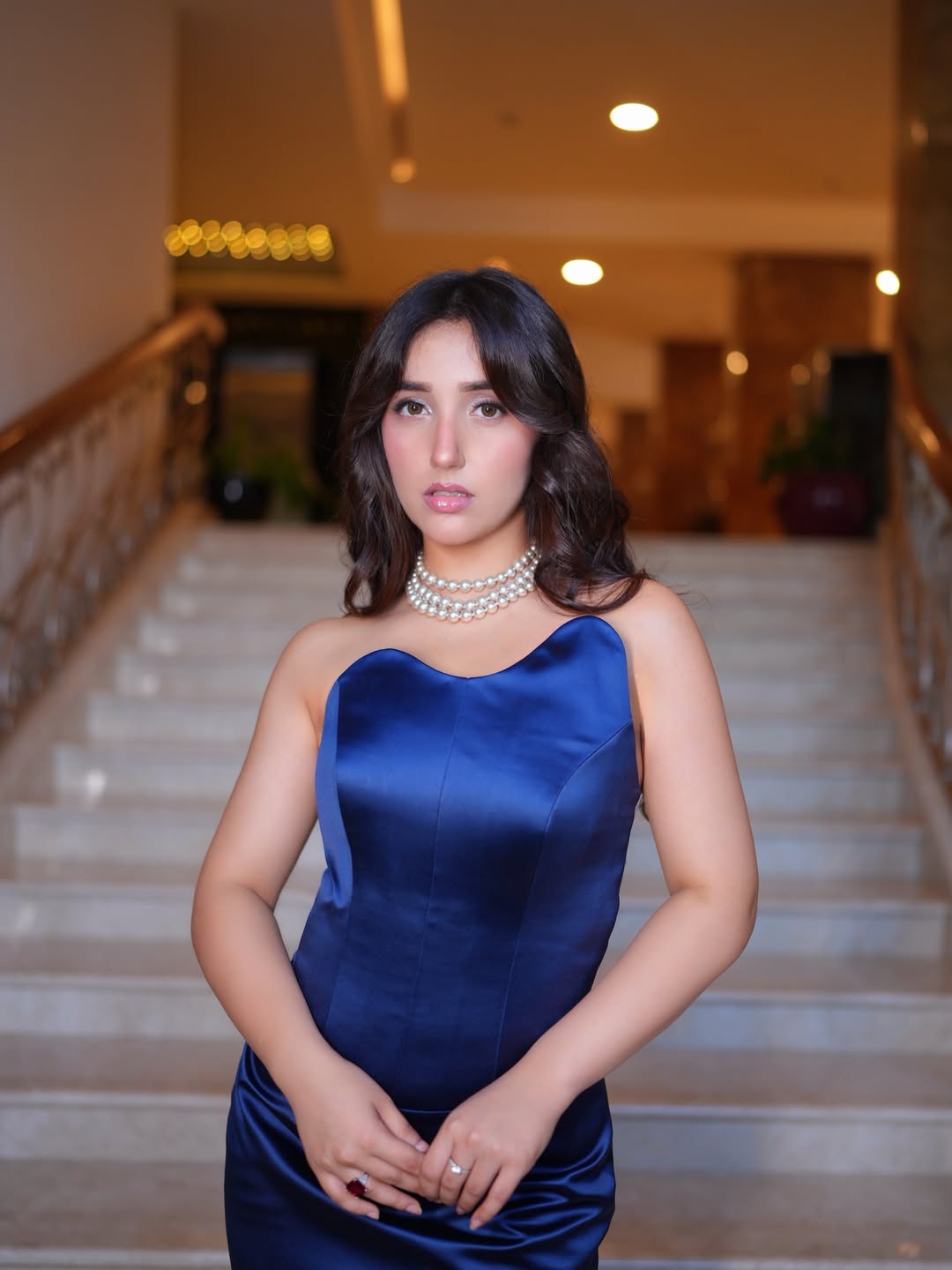 Ashnoor Kaur wearing navy gown and pearls