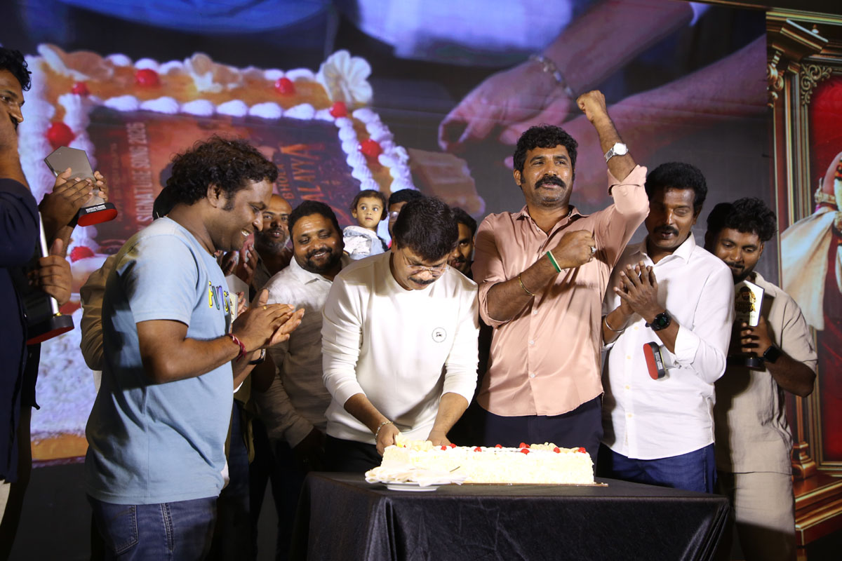 Team cutting cake at launch