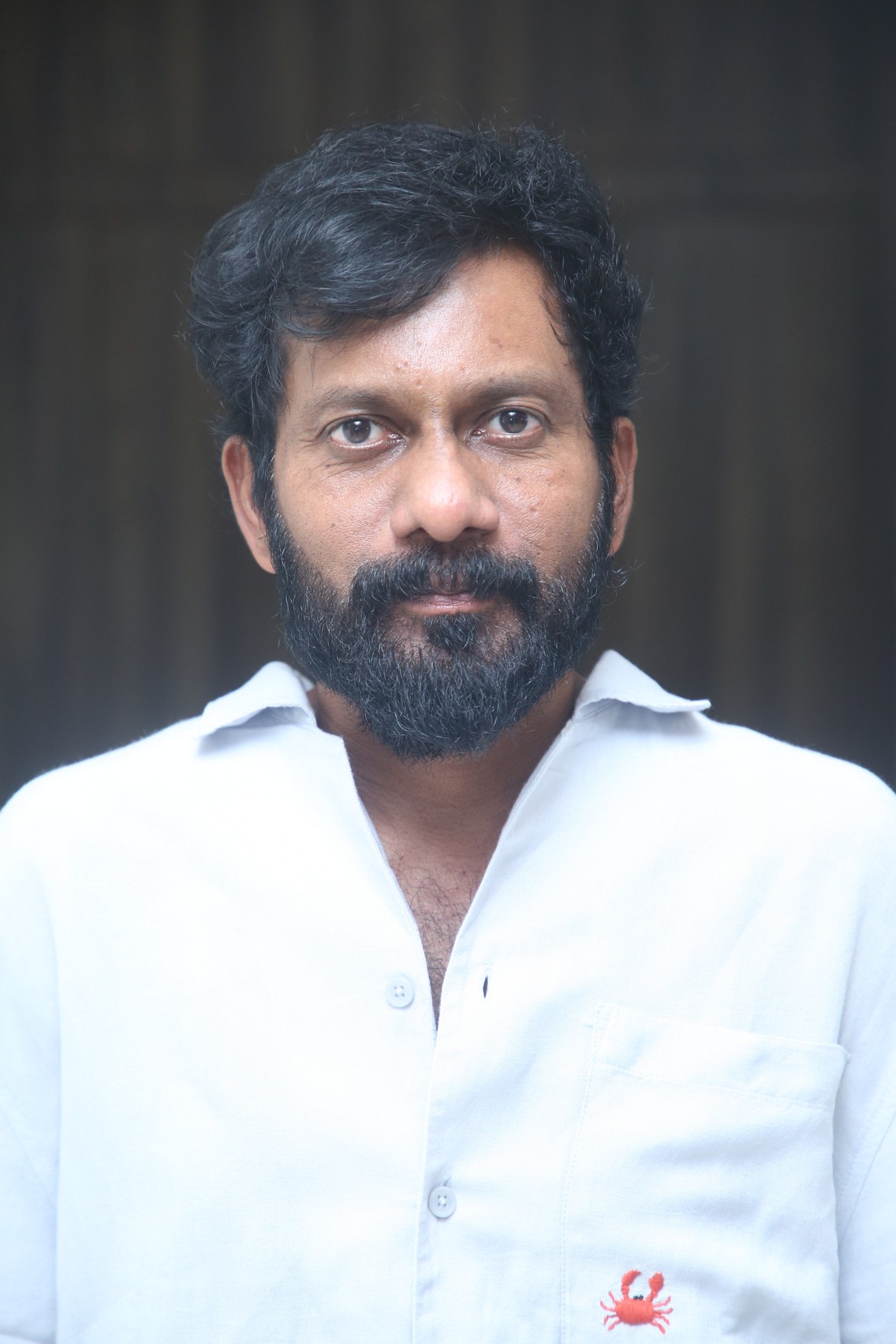 Buchi Babu Sana poses in stylish formal attire