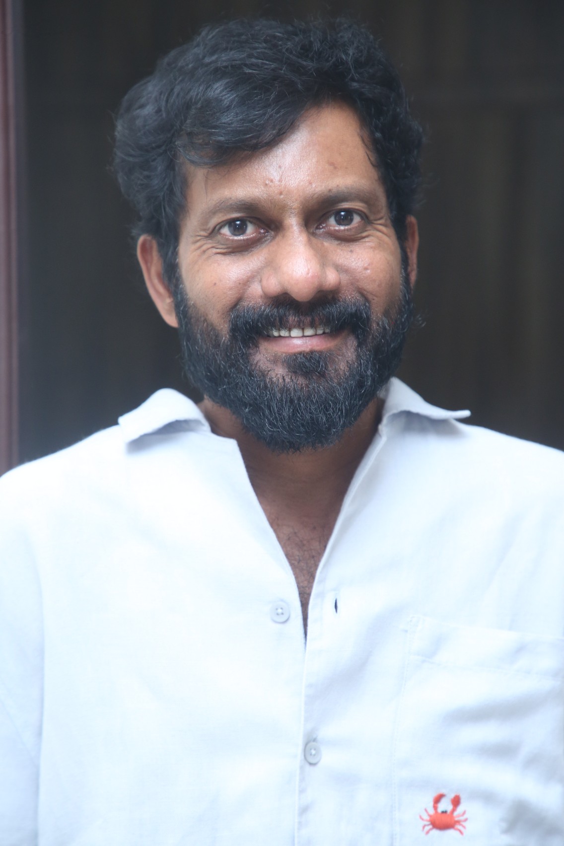 Buchi Babu Sana in classic white shirt portrait
