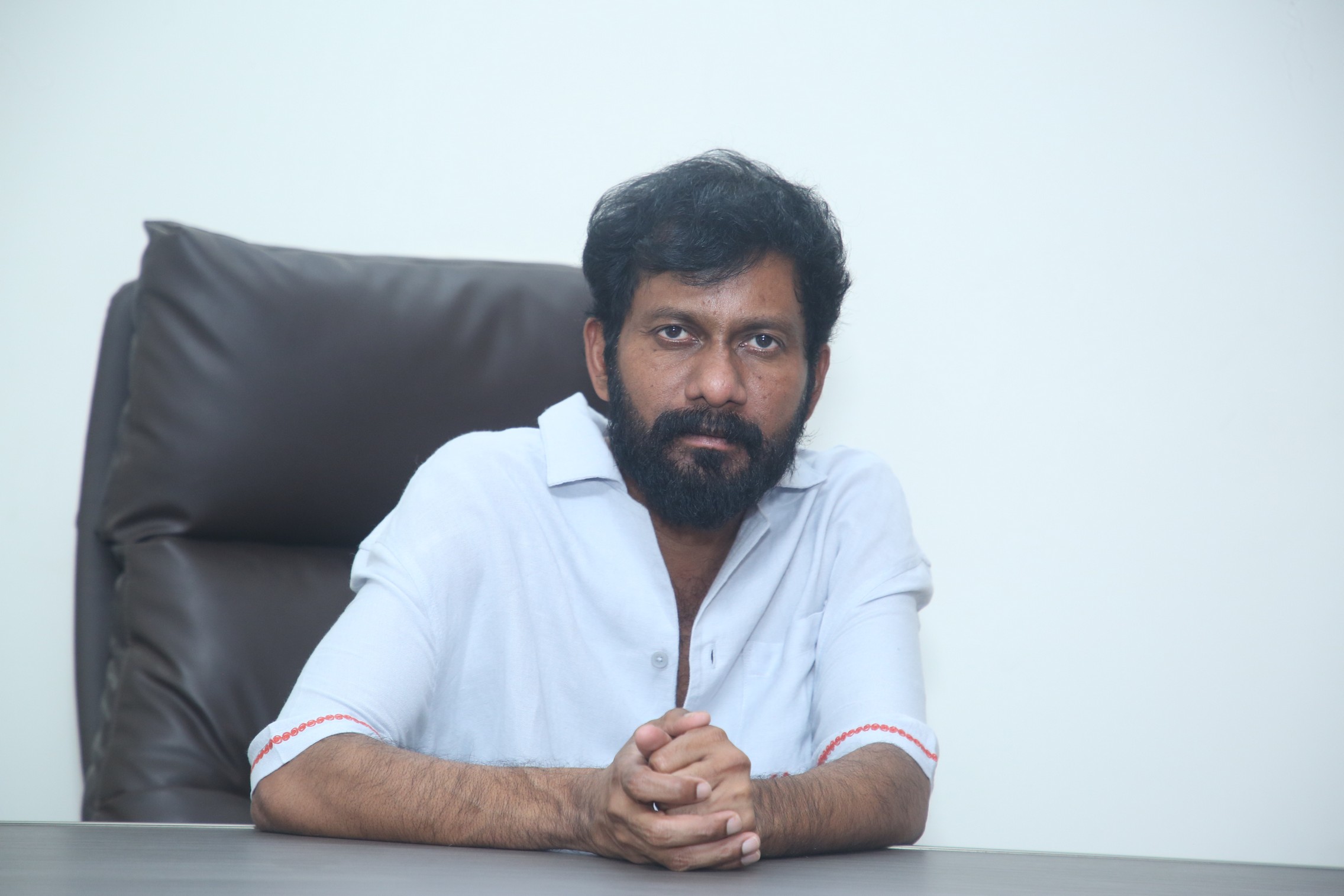 Buchi Babu Sana posing confidently in smart attire