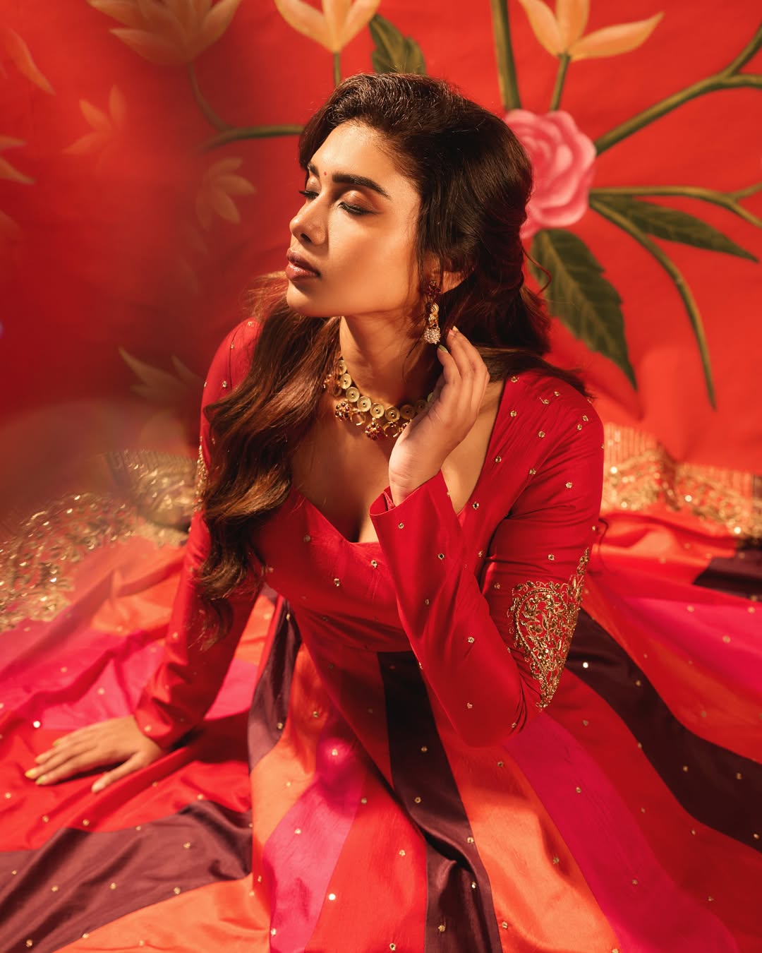 Dushara Vijayan in a flowing red and purple fashion ensemble.
