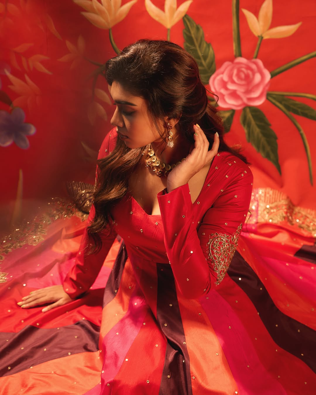 Dushara Vijayan stunning in a stylish red and purple outfit.