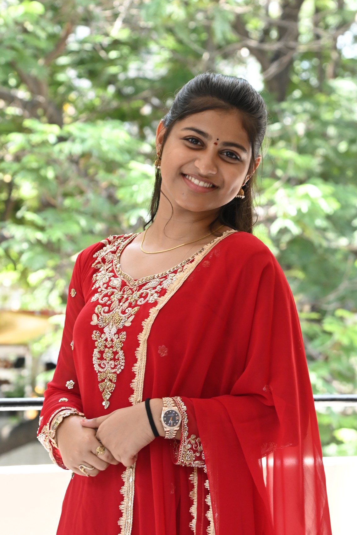 Likhitha in red and gold ensemble
