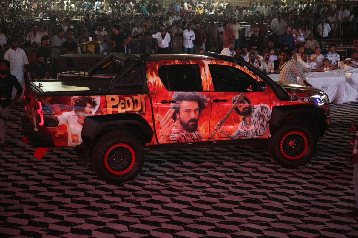 Toyota Hilux wrapped with Peddi movie promotional artwork at event.